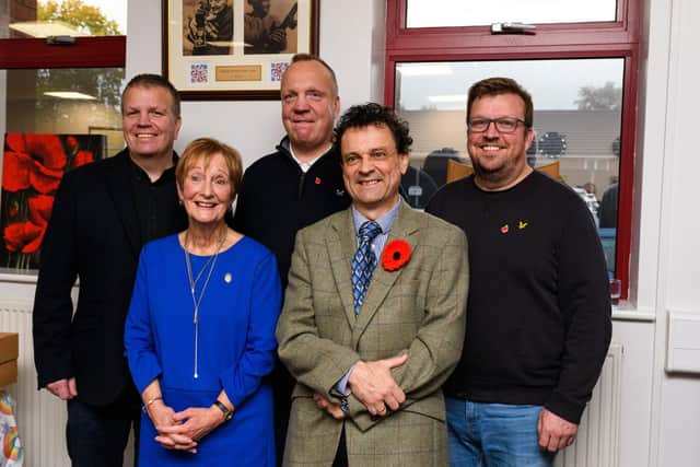 (back row l-r) Danny, Andrew and David Atherton, grandsons. (front row) Daughter Glenys Atherton and author Damien Lewis in front of the plaque in tribute of Corporal Tom 'Ginger' Jones.