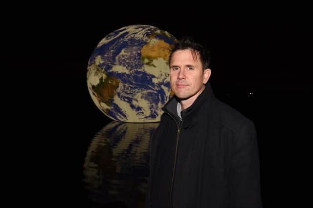 Artist Luke Jerram with his artwork