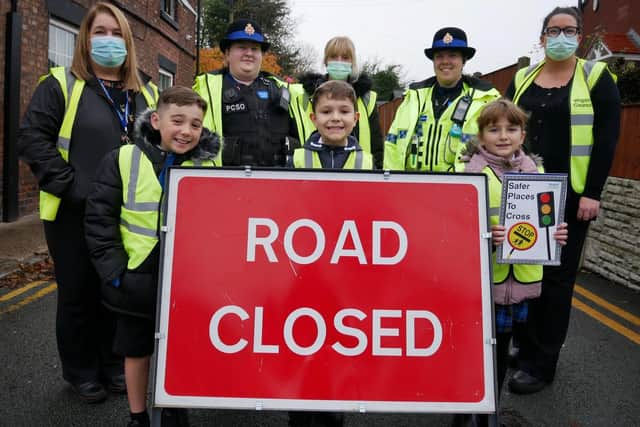 Police, school staff and pupils outside St Peter's