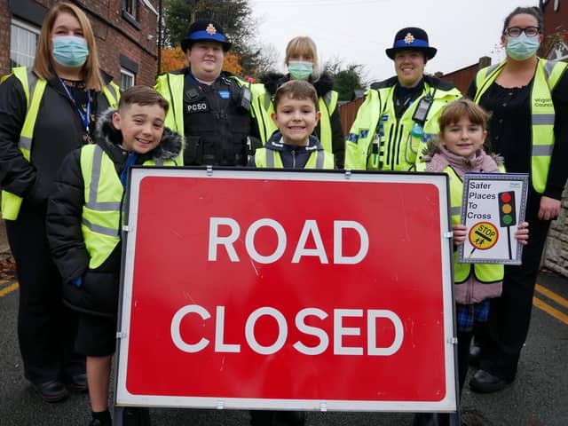 Police, school staff and pupils outside St Peter's