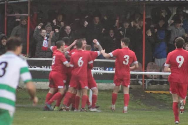 The bumper crowd at Ashton Town celebrate the late winning goal