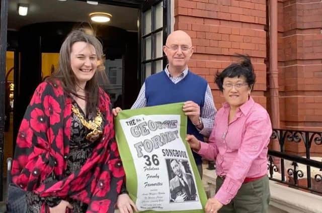 Blackpool Mayor Coun Amy Cross (left) is presented with a commemorative George Formby tea towel