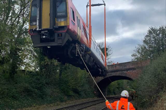 One of the stricken carriages is lifted off the tracks by an Ainscough crane