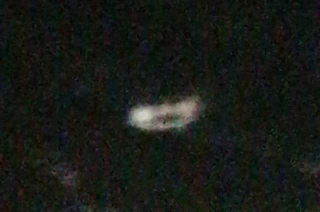 The saucer-shaped object hovering in the air