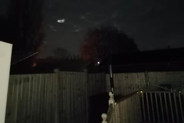 The UFO is hovering quite low over houses