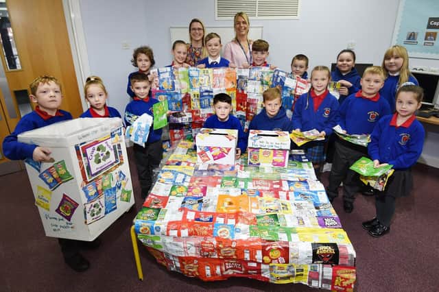 Headteacher Helen Smart, back left, and teaching assistant and eco-team leader Eve Parkes, back right with students at Worsley Mesnes and their survival blanket