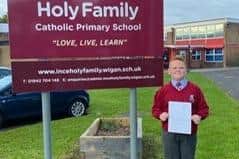 Toby outside the school with a copy of his letter