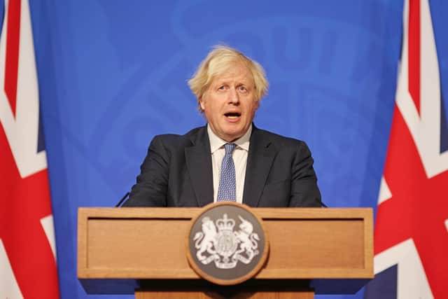 Prime Minister Boris Johnson speaking at a press conference in London's Downing Street after ministers met to consider imposing new restrictions in response to rising cases and the spread of the Omicron variant.