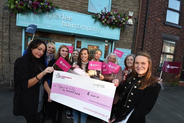Katie Grice, left, and Donna, directors at Tyler Lee, Pemberton, celebrate being awarded a £10,000 National Lottery grant with staff and supporters of the project