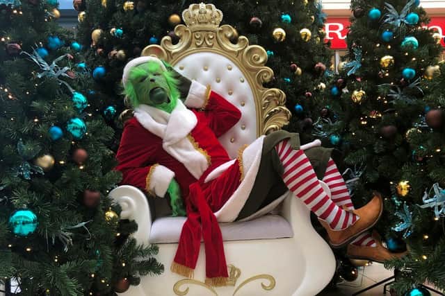 The Grinch on Santa's chair