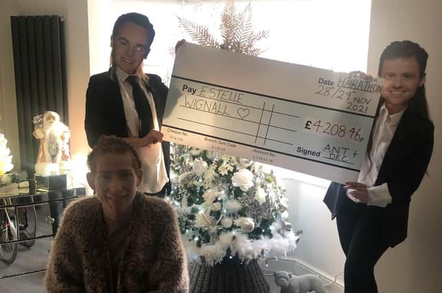 Claire Petrie and Kelly Jones deliver the cheque to Estelle Wignall