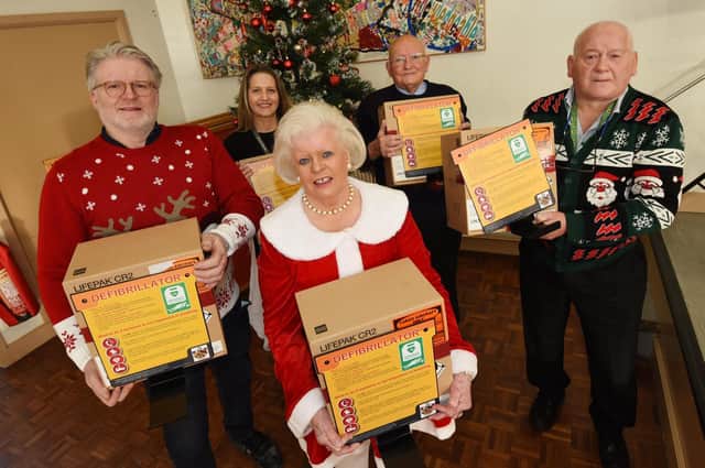 From left, Simon Yates, Sharon Travers from Atherton St George's primary school who are one of the recipients of the life-saving equipment, Val Houghton, Norman Bradbury and Alan Birtles.
