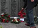 Tributes were placed at a memorial naming all the men who died