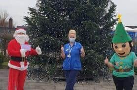 Santa and Coco the Elf with a healthcare worker