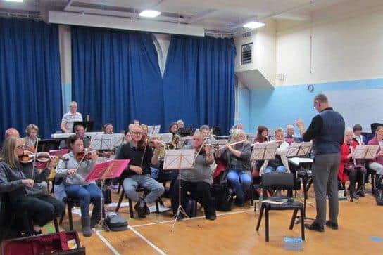Chris Perry puts the orchestra through its paces