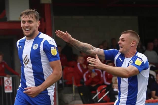 Max Power and Charlie Wyke celebrate during Latics' 4-0 victory at Accrington