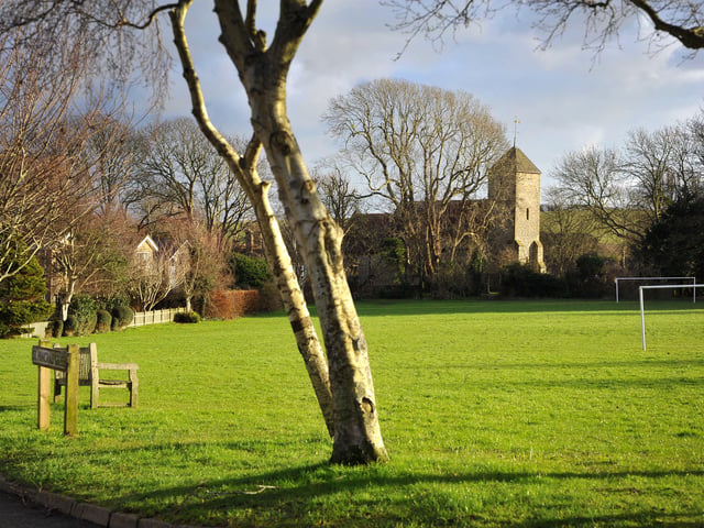 The village is mentioned in the Domesday Book and is located two miles (3.2 km) south of Lewes .