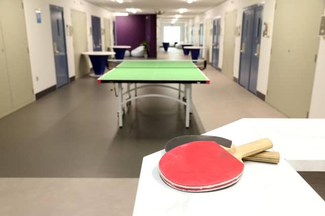 Residents with super enhanced status get extra privileges including buying their own food to cook in a communal kitchen or do their own laundry