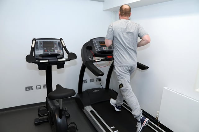 A prisoner, who has already served 18 years and has another seven until his release, completes a 5km run in one of the house block's 'cardio rooms'