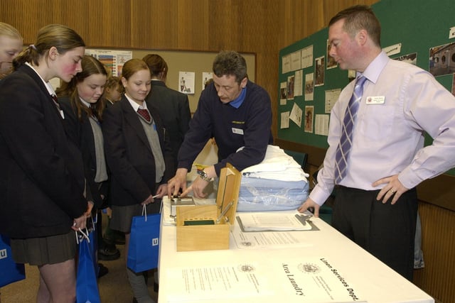 Linen Services staff Trevor Lynch and Andrew Bloomer talk to pupils from Lisneal College during a careers day held at Altnagelvin on Tuesday last. (3103PG05)