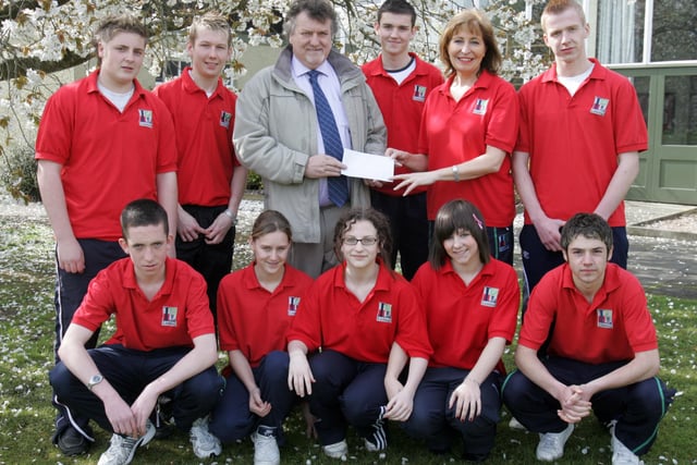 Alan McKay, Lisneal College PTA, presenting a cheque to Mrs. Geraldine McKay, event organiser & relay team member, to help cover egistration fees and costs of the Lisneal College team who are to participate in this year's Belfast Marathon in aid of Children in Crossfire. Front, from left are Scott Rankin, Mandy Hutchenson, Lynzi Thomas, Carla McGregor and David Connor. Included at back are Leigh Bronze, Gareth Strain, Steven Giff and Lee Tinney. (2804C30)