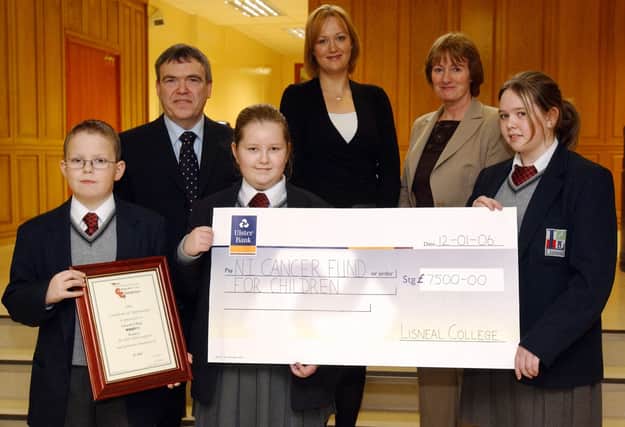 Pupils from Lisneal College present the Northern Ireland Cancer Fund for Children with a cheque for £7,600, raised by asking family and friends to sponsor them as they read their way through a variety of books during READ-ON week. Included, from left, Andrew Taylor, David Funston, principal, Emma Smallwoods, Jude Austin, Northern Ireland Cancer Fund for Children, Elizabeth Mills, READ-ON co-ordinator, and Nikita Hornby. (1301PG09)