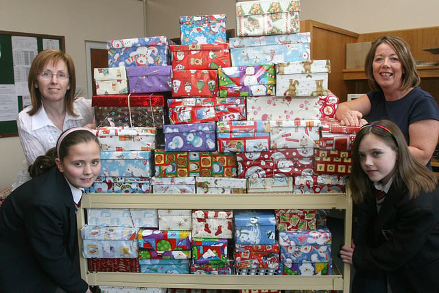 Pupils Ainee Peoples and Yasmin along with staff members Josephine Gurney and Joan Simpson, with the collection of 106 shoeboxes collected by first year pupils at Lisneal College. The shoeboxes are for 'Operation Christmas Child, a project of  The Samaritan's Purse, and will be given as a gift to children in Eastern European countries. LS46-527MT.