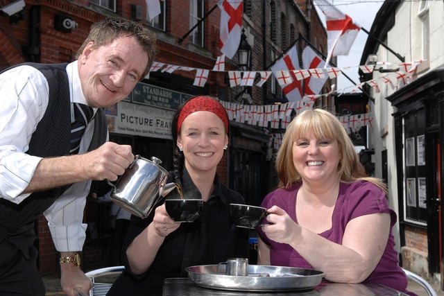 TEA AND BUN-TING...Howard Gallimore, owner of Gallimore's Restaurant in The Wiend, waitress Carly Miller and Janet Hall, owner of The Wiendbar, get set to celebrate St George's Day with a cup of tea, 2009