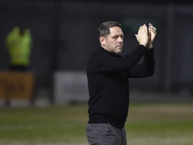 Leam Richardson salutes the fans at Crewe