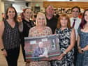Event organisers hold a photo of Barbara.