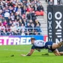 England's Tom Johnstone scoring a try against Tonga at the Totally Wicked Stadium