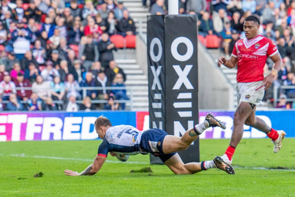 England's Tom Johnstone scoring a try against Tonga at the Totally Wicked Stadium