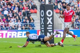 England's Tom Johnstone scoring a try against Tonga at the Totally Wicked Stadium