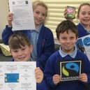All Saints Primary School's Fairdo group proudly display their certificates
