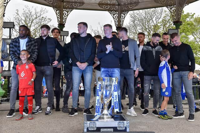 The Latics squad celebrate with their League One title