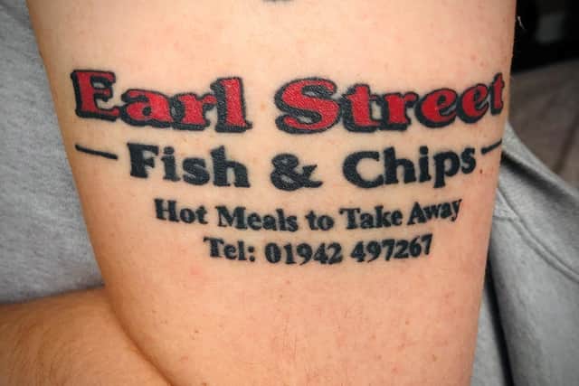 The local loved the chippy so much that he got the signage tattooed on his arm, landline included!