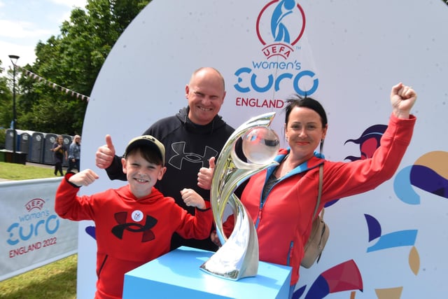 from left, Ethan Lee, ten, Stan Lee and Rachel Gore with the Women's Euro 2022 trophy.