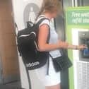 A commuter using the new water dispensers set to be installed in Northern train stations