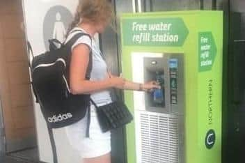 A commuter using the new water dispensers set to be installed in Northern train stations