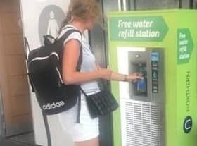 A commuter using the new water dispensers set to be installed in Northern train stations