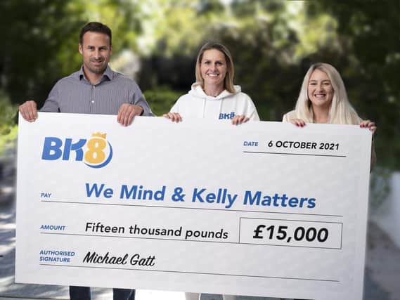 Photographed presenting a previous donation to the charity is BK8 European Managing Director Michael Gatt with We Mind & Kelly Matters Patron Kelly Smith MBE and Amy Hewitt from the charity. 