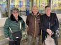 (L-R) Ann and Pete Quigley with Brenda Wainwright standing at a bus stop on Market Street, Atherton