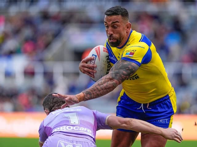 Warrington Wolves prop Paul Vaughan is tackled by Jai Field of Wigan Warriors at Super League's Magic Weekend