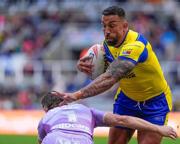 Warrington Wolves prop Paul Vaughan is tackled by Jai Field of Wigan Warriors at Super League's Magic Weekend