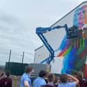 The 3-D mural nears completion, watched by students from St. John's Primary School, where James McClean was educated (Pic: @feilederry)