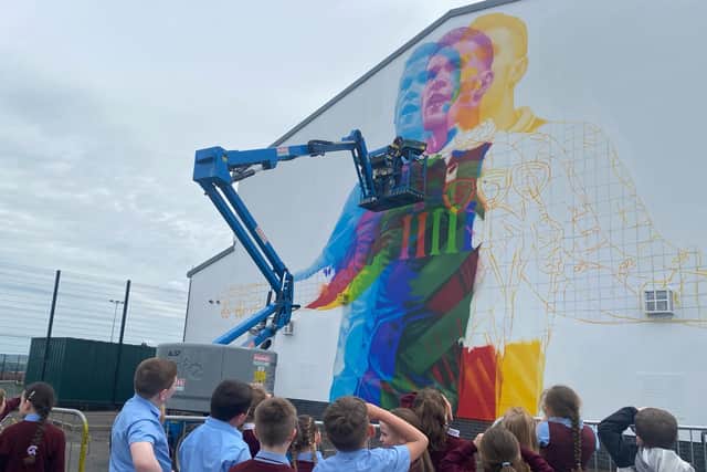 The 3-D mural nears completion, watched by students from St. John's Primary School, where James McClean was educated (Pic: @feilederry)