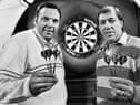 World darts stars Cliff Lazarenko, left, and John Lowe ready to compete at the LUT buses depot in Atherton.