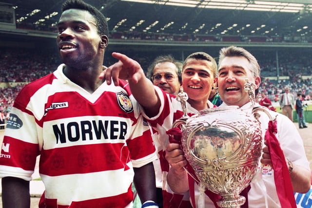 Triumphant trio, Martin Offiah, Jason Robinson and coach John Monie look for family and friends in the Wembley crowd as they parade the trophy after beating Widnes 20-14 in the Challenge Cup Final at on Saturday 1st of May 1993.