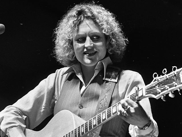 Barbara Dickson on stage on Saturday July 16th at the 1977 July Wakes Folk Festival at Park Hall, Charnock Richard. It was a 3 day event and featured top acts of the day including Fairport Convention, Gallagher and Lyle, Leo Kottke and Country Joe McDonald.