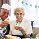 Chef Wayne Woolman and resident Joyce Wardle have been busy baking for Macmillan